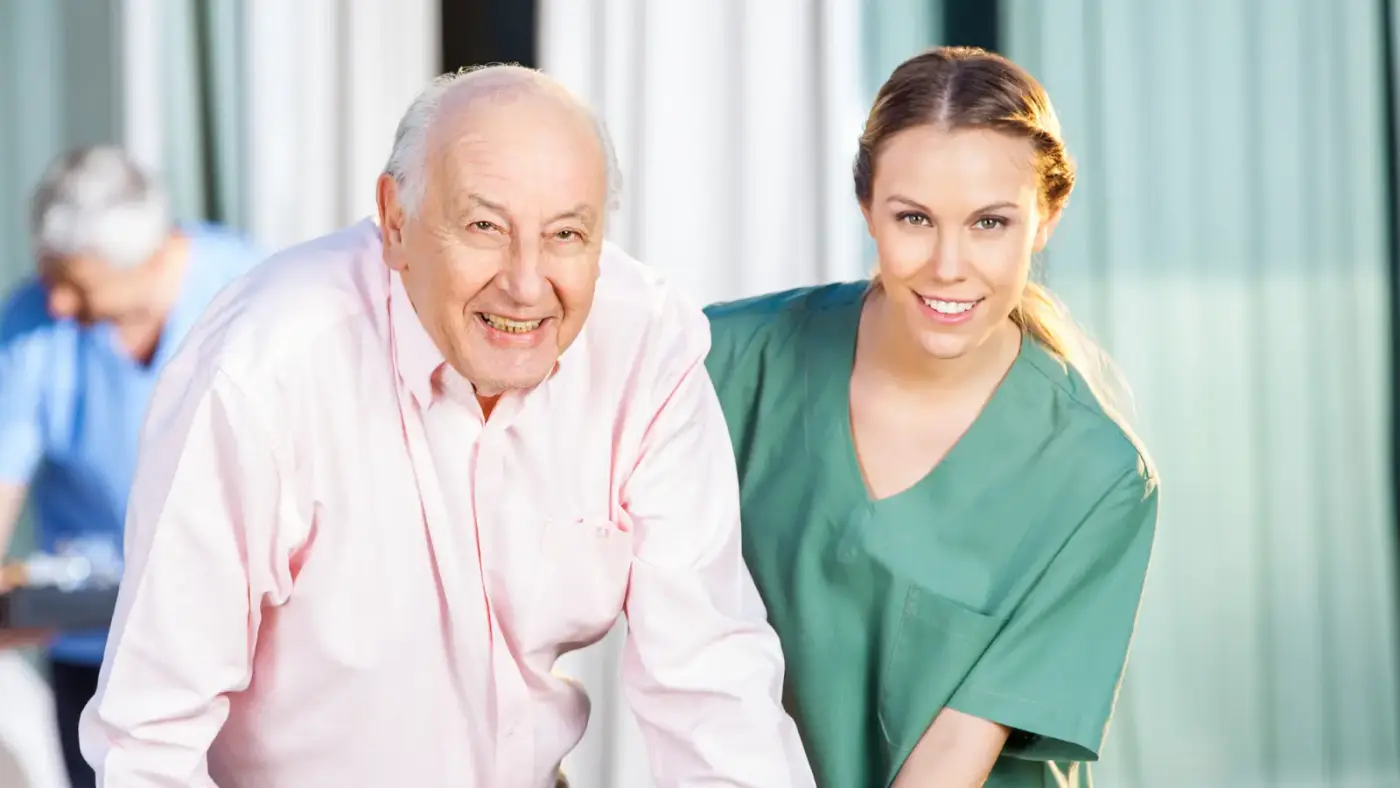 happy resident being helped my nurse/carer