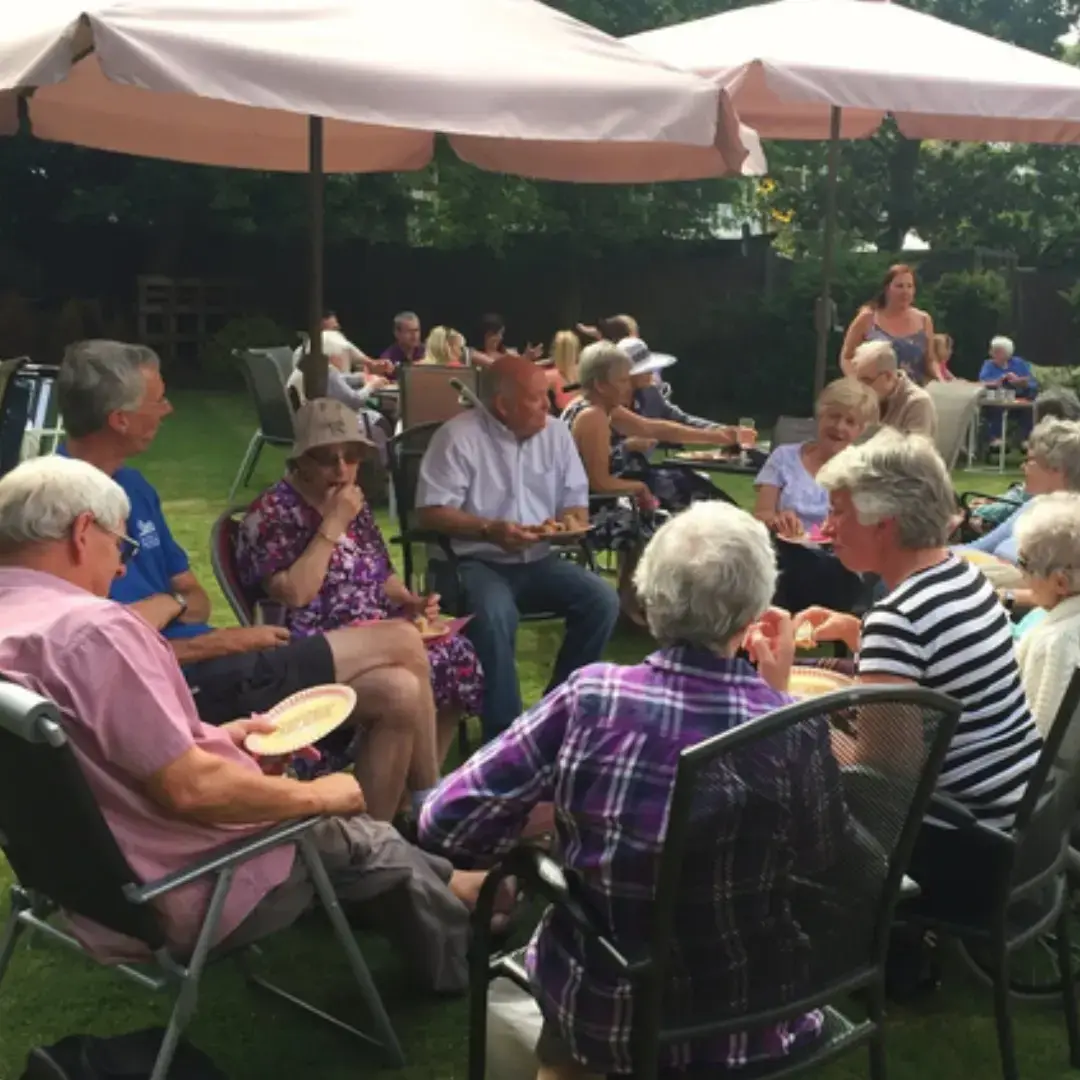residents having a chat under cover in garden