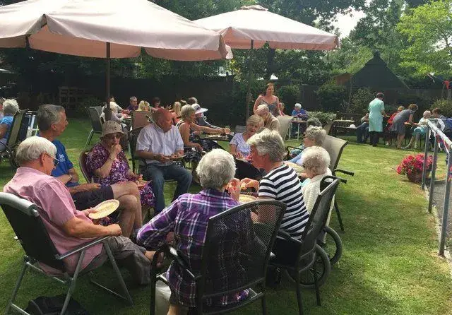 residents enjoying sunshine in garden