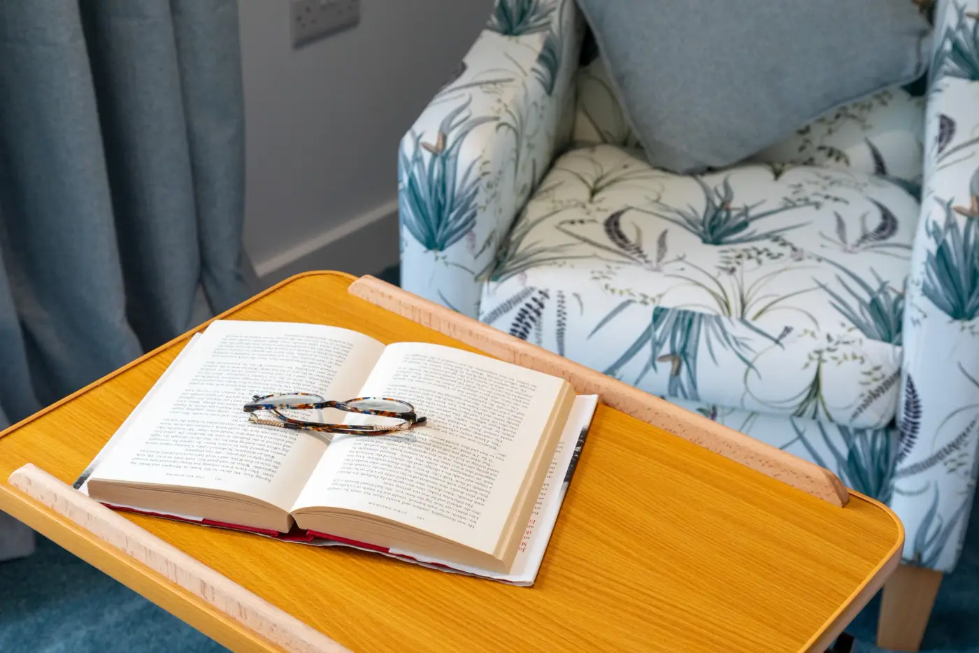 book with glasses on and armchair